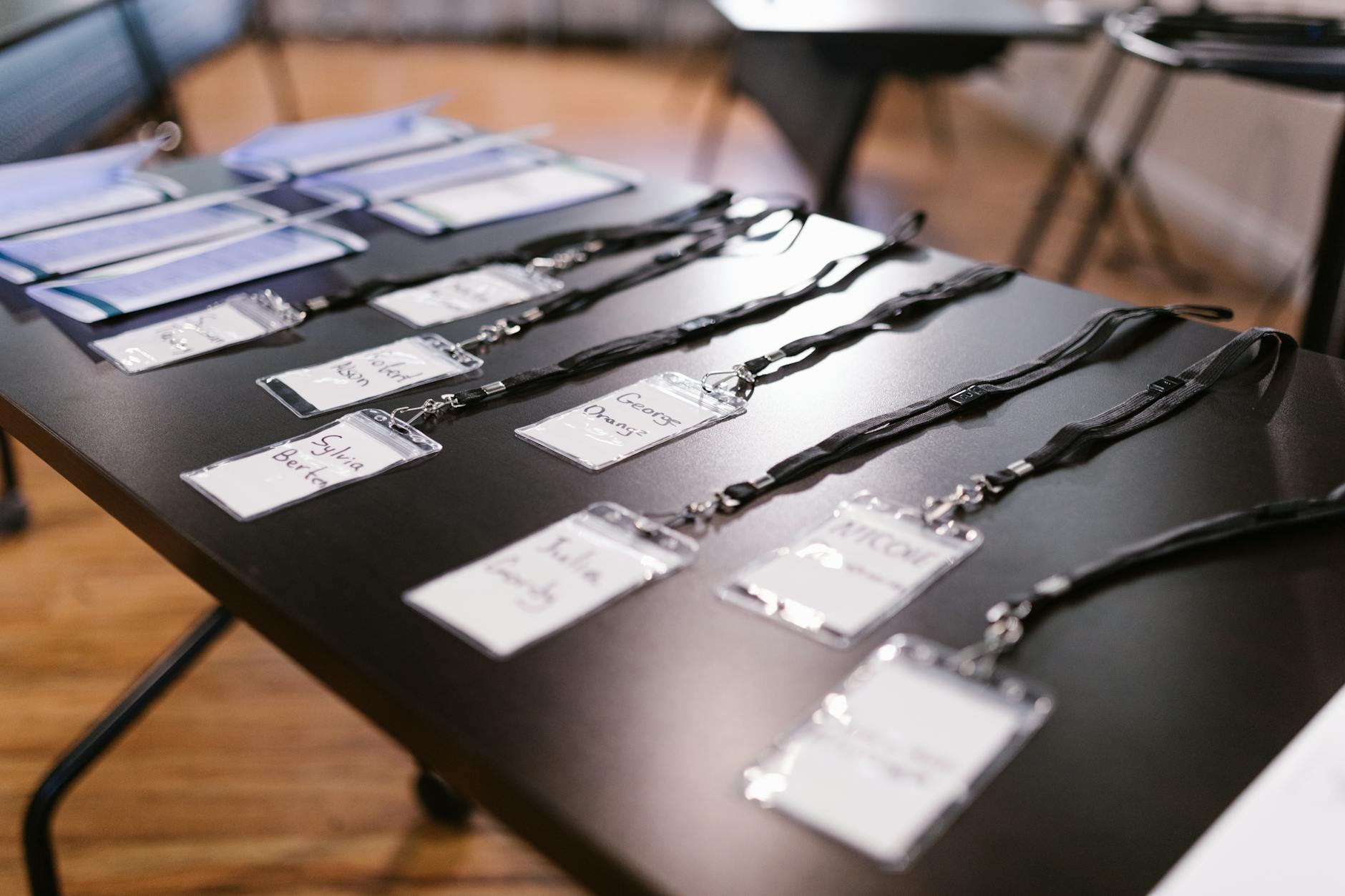 Conference name tags and folders on a registration table